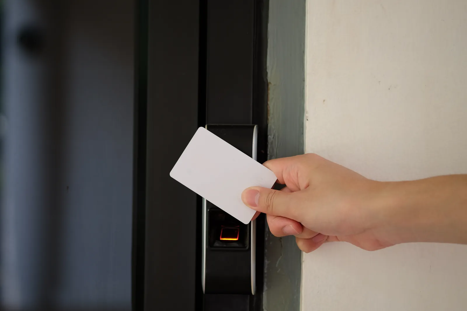 Access card presented to a wall-mounted door reader